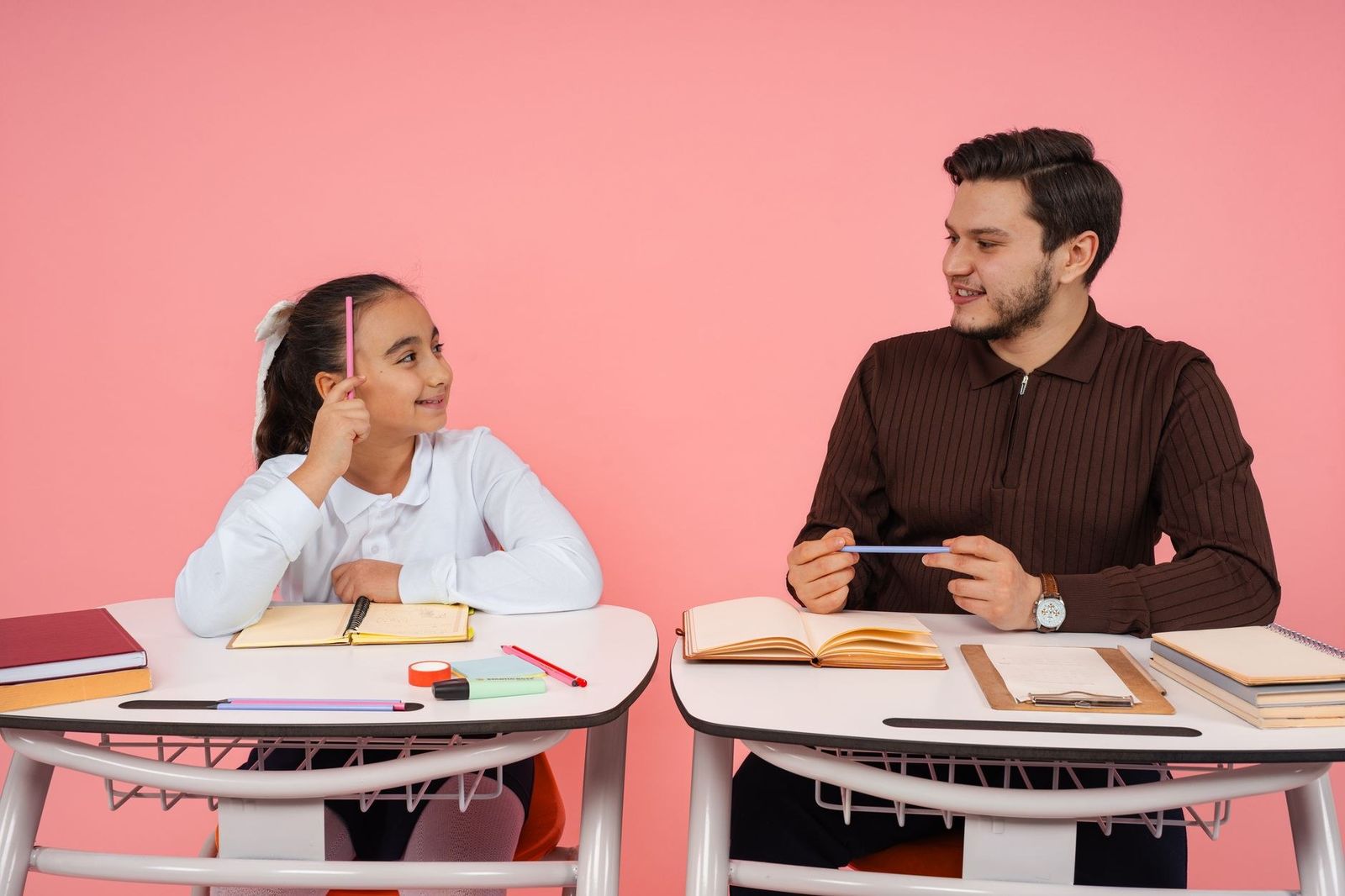 A teacher and student engaging in a lively discussion at school.
